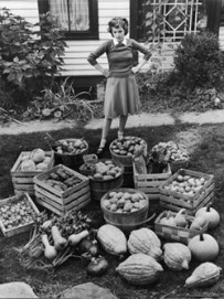 592295~Woman-Looking-at-Victory-Garden-Harvest-Sitting-on-Lawn-Waiting-to-Be-Stored-Away-for-Winter-Posters